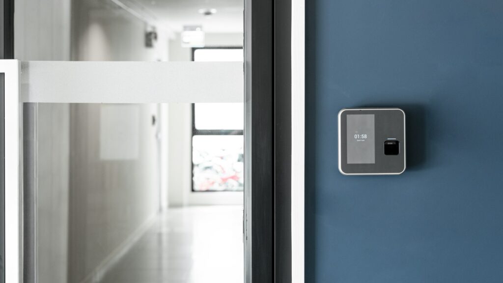 Finger or card scanner device placed on blue wall to unlock the entrance door